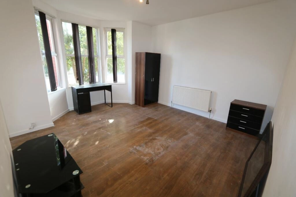 Before: St John's empty living room with worn wooden floor and dated finishes
